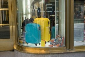Blue yellow suitcases in window shop