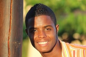 smiling handsome dark skin young man outdoor, portrait