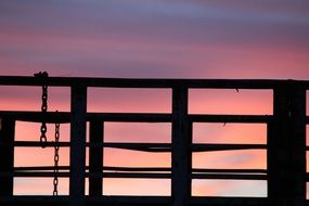 dark metal railing in colorful evening sky