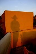 shadow of a texas cowboy on a cube