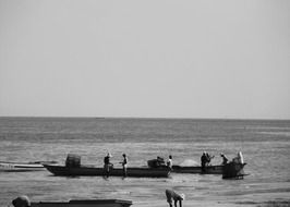 Black and white photo of men in Fishing boats