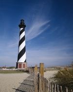 striped lighthouse on the shoreline