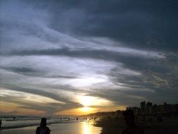 magnificent sunset on a quiet calm beach with silhouettes