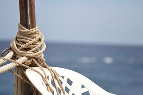 rope on a stick near the chair