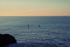 kayaks on the ocean at dusk