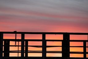 colorful sunset with clouds and silhouette of the bridge