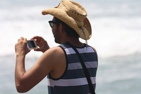 iphone photographer tourist at tropical beach