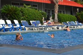 Kids are swimming in the pool
