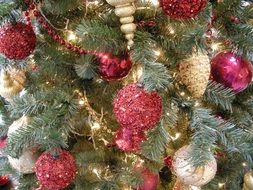 red decorations on a christmas tree close-up