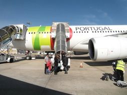 people with traveling bags at aircraft