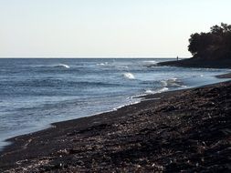 sea waves on black beach in santorini