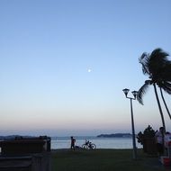 silhouette of the promenade near the sea at dusk