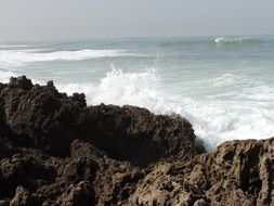 ocean waves on big stones