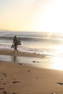 Distant view of a surfer on a beach in Biarritz