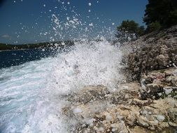 water splashes near the rocks