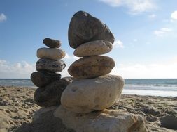 balanced tower of stones on the beach