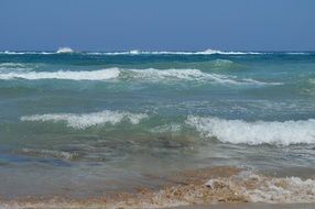 waves on the coast of crete on a sunny day