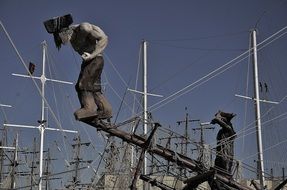 man sculpture on the mast in sailing