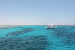 boat in bright waters off the coast of egypt