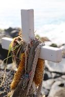 cross on the beach as a memory of the dead