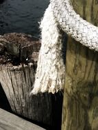 thick rope on a wooden pier close-up