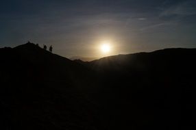 silhouettes of people at sunset in the desert
