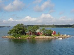 red wooden house on the island