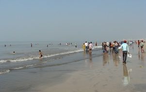 People on a sandy beach in mumbai, india