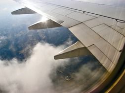 Wing of an airplane above the clouds