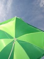 Green sun umbrella on the holiday