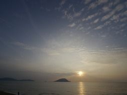 small island in the background of the sea sunset