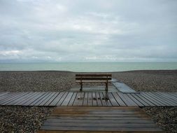 bench and wooden walkways on the beach