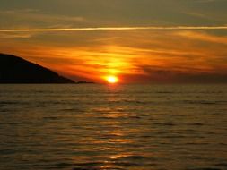 colorful cirrus clouds at sunset sky above sea