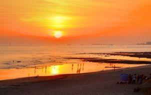 bright orange sky during sunset over the sea