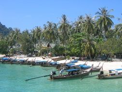 remote view of boats on the tropical coast of thailand