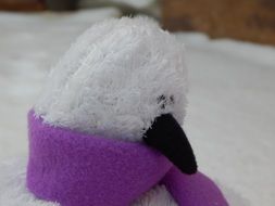 toy bird with a purple scarf