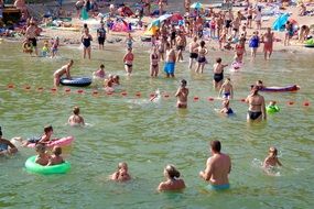 people bathe in a lake in poland