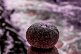 round stone on the background of the river