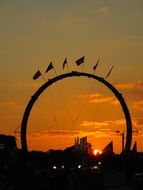 archway with circus flags on orange sky background