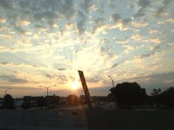 rays of the setting sun through the clouds