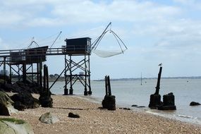 fishing equipment and cabins on piles on beach