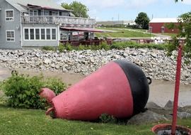 red and black buoy on lawn at building