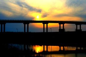 bridge silhouette against sunset sky