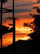 electrical wores on pillar at sunset sky
