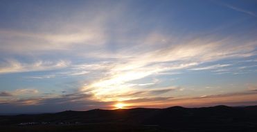 bright sun breaks through the twilight on the horizon