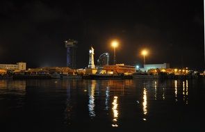 seafront with street lamps at night in barcelona