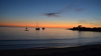 boats on the sea against the background of sunrise