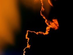 fire behind the cloud in the evening