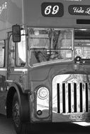 black and white photo of a tourist bus in london