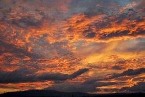 orange sunset in gray clouds
